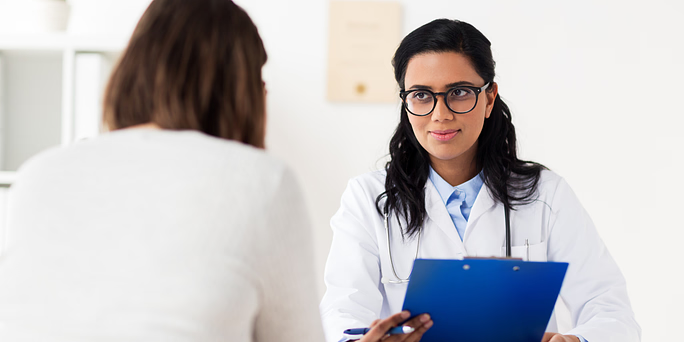A woman talking with a doctor on what to know before an abortion